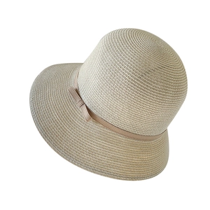 Elegant khaki woven straw sun hat with bow tie decoration and minimalist round top design