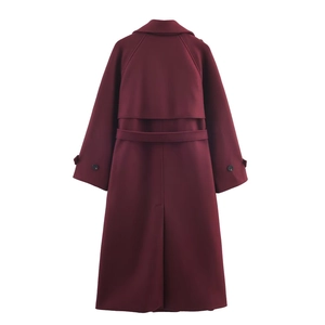 Detail view of the back of a deep burgundy wool coat with a belt and center slit