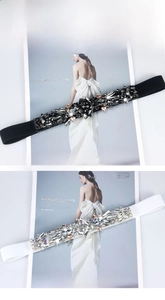 Detailed view of elastic waist belts featuring intricate white crystal and rhinestone patterns