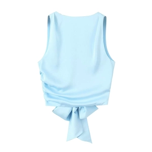 Detail of the light blue satin crop top showing the back tie-up bow and smooth silk texture