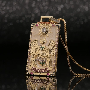 Detail of Lovers tarot card necklace with colorful zircons and golden square chain link