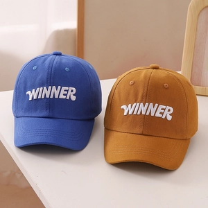 Detailed close-up of 3D Winner letter embroidery on cotton twill baseball caps