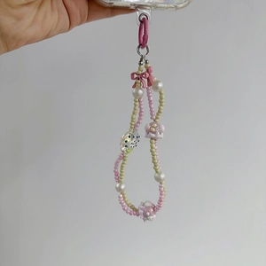 Pink and beige beaded phone charm with strawberry and bow designs for women