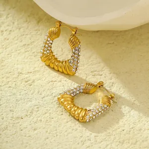 Detailed macro view of 18K gold-plated geometric hoop earrings with zircon micro-pave