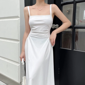 Detailed close-up of white ruched waist design on minimalist elegant midi dress