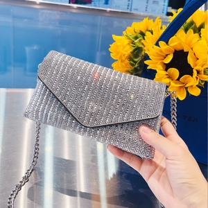 Detailed view of silver envelope clutch bag with sparkling rhinestones and chain strap