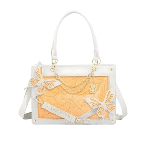 Detail of white butterfly ita bag with spider web window and gold chain decoration