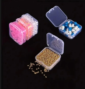 Macro detail of clear plastic organizer box with small beads and accessories