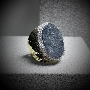 Detail of grey-blue crystal cluster ring with zircon halo and hammered bronze finish