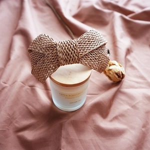 Detailed view of a French retro raffia woven bow headband with delicate straw texture