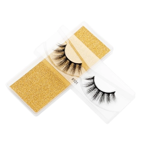 Macro shot of #101 3D faux mink eyelashes with multilayered fibers on gold glitter card