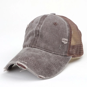 Close-up of distressed washed canvas and breathable mesh detail on a vintage baseball cap