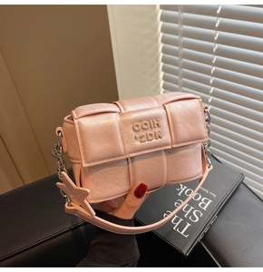Détail du sac à bandoulière tressé rose avec chaîne argentée et pendentif étoile