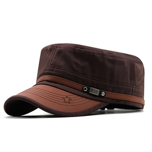 Detail of dark coffee military cap with brown leather brim and star embroidery
