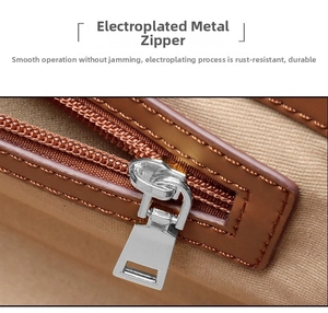 Macro shot of silver plated metal zipper and fine stitching on a brown leather tote bag