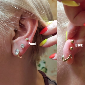 Front and back view of crystal stud earrings and gold hoops on ear for multiple piercings