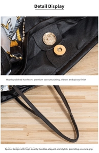 Polished gold magnetic clasp and chain pattern silk lining on black faux leather tote