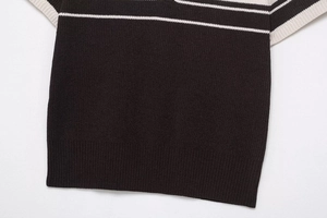 Detailed view of dark rib knit fabric with white stripes and contrast stitching