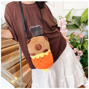 Detailed view of a cute Capybara plush crossbody bag worn on a black shoulder strap