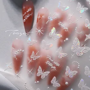 Macro shot of white and laser butterfly nail stickers with stars and lunar motifs