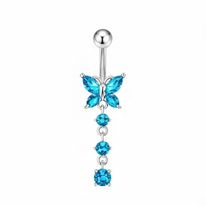 Detail of silver belly ring featuring butterfly wings and light blue gemstone tassels