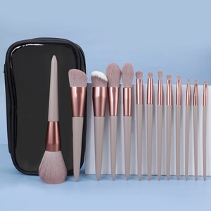 Detail of 13-piece makeup brush set with purple bristles and rose gold ferrule in a case