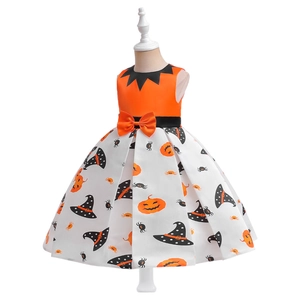 Detailed view of Halloween kids dress featuring pumpkin patterns and orange bow