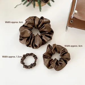 Brown leather hair scrunchies in three sizes, 1.5cm, 4cm, and 6cm widths, elegant style