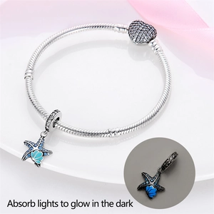 Silver snake chain bracelet with luminous blue enamel starfish and crystal charm pendant