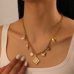 Close-up of vintage gold-plated stainless steel necklace with butterfly and heart charms