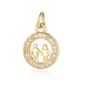 Macro detail of a gold circle pendant with zircon stones and boy-girl holding hands design