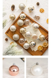Detailed view of assorted Christmas ornaments with glitter and matte finishes on wooden tray