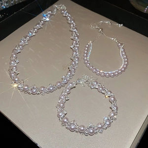 Macro view of rose pearl necklace with sparkling rhinestones and elegant wavy metal lines