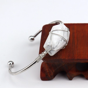 Silver wire wrapped cuff bracelet featuring a natural white turquoise stone on wood