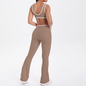 Detail of flared yoga pants with high waist and white contrast piping on brown fabric