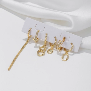 6-piece gold chain link earrings set with sparkling zircon stones on white silk