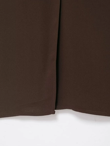 Detail shot of chocolate brown fabric with fine stitching and smooth matte texture