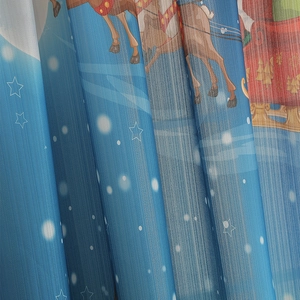 Detail of blackout curtain fabric featuring blue Christmas reindeer and starry sky patterns