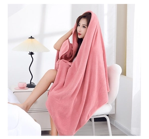 Detail of pink coral fleece hooded bath towel with absorbent waffle weave texture