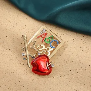 Artistic teacher brooch with red apple, pencils, and crystal ABC letters, 5.5x5.6cm design