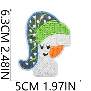 Detailed view of white letter embroidery patch with size markers 6.3x5cm and green accents