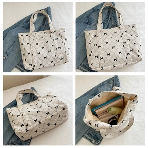 Interior view of white corduroy tote bag showing large capacity for books and tablet