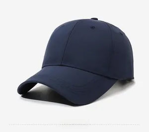 Detail view of a navy blue cotton baseball cap with classic 6-panel design and curved brim