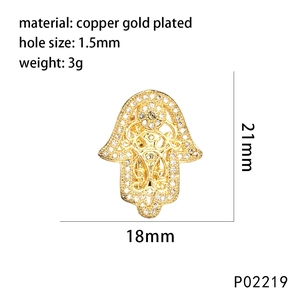 Detailed view of a gold-plated Hamsa Hand charm with micro-pave cubic zirconia stones