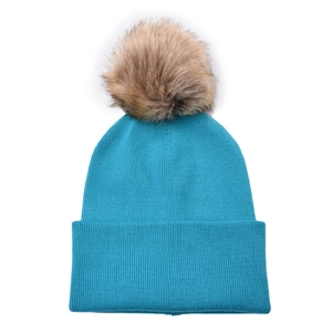Detail of sky blue ribbed knit beanie featuring a large detachable faux fur pom-pom