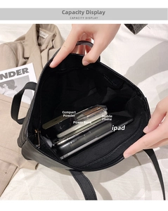 Top macro view of black leather hobo bag interior with zip pocket showing large capacity