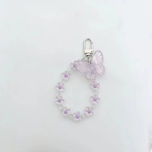 Detail of purple butterfly charm with floral acrylic beads and silver lobster clasp