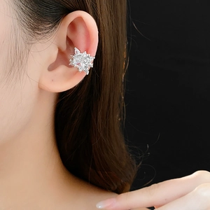 Detailed close-up of a silver snowflake ear cuff featuring sparkling zircon stones