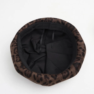 Detail of leopard print beret featuring black inner lining and adjustable drawstring