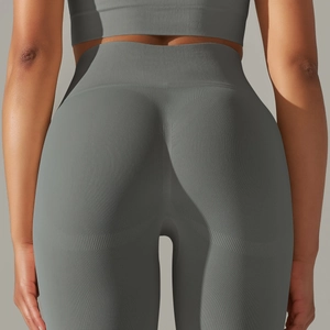 Détail montrant la texture en maille sans couture et l'effet push-up du legging de yoga gris